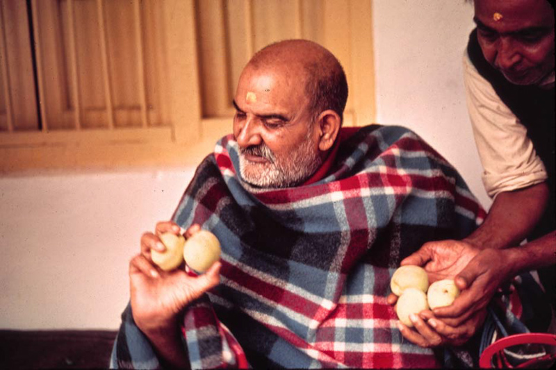 Maharaj-ji receiving prasad